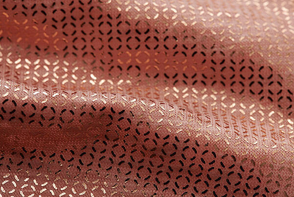 Detail of a woven fabric with a golden textile finish from KURZ